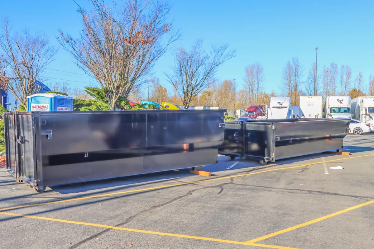 Professional dumpster rental service with roll-off container on residential driveway in Braintree Town